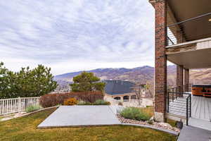 View of yard with a mountain view, a patio area, and a balcony