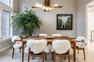 Dining room with light tile patterned floors and baseboards