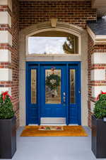 Doorway to property with brick siding