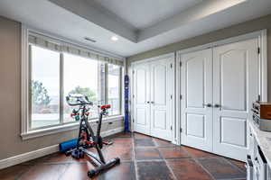 Exercise room featuring a textured ceiling and recessed lighting