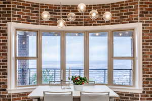 Dining space with brick wall and a water view