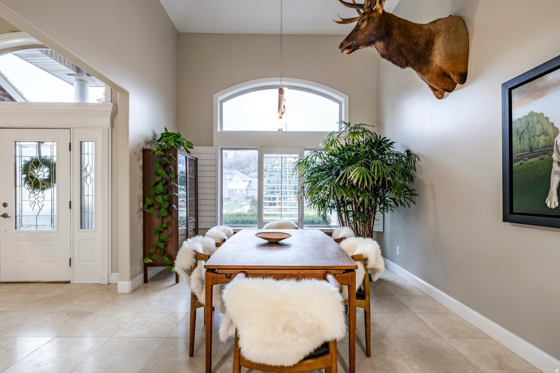 Dining space with a high ceiling and light tile patterned flooring
