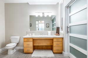 Bathroom featuring decorative backsplash, vanity, and light tile patterned flooring