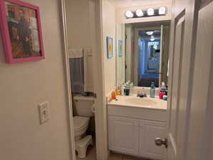 Half bath with vanity and light tile patterned floors