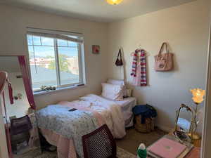 Carpeted bedroom with a textured ceiling and baseboards
