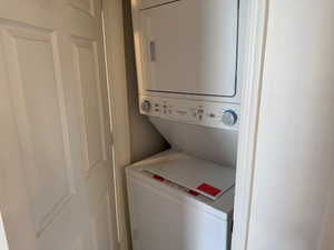 Laundry area with stacked washer and dryer