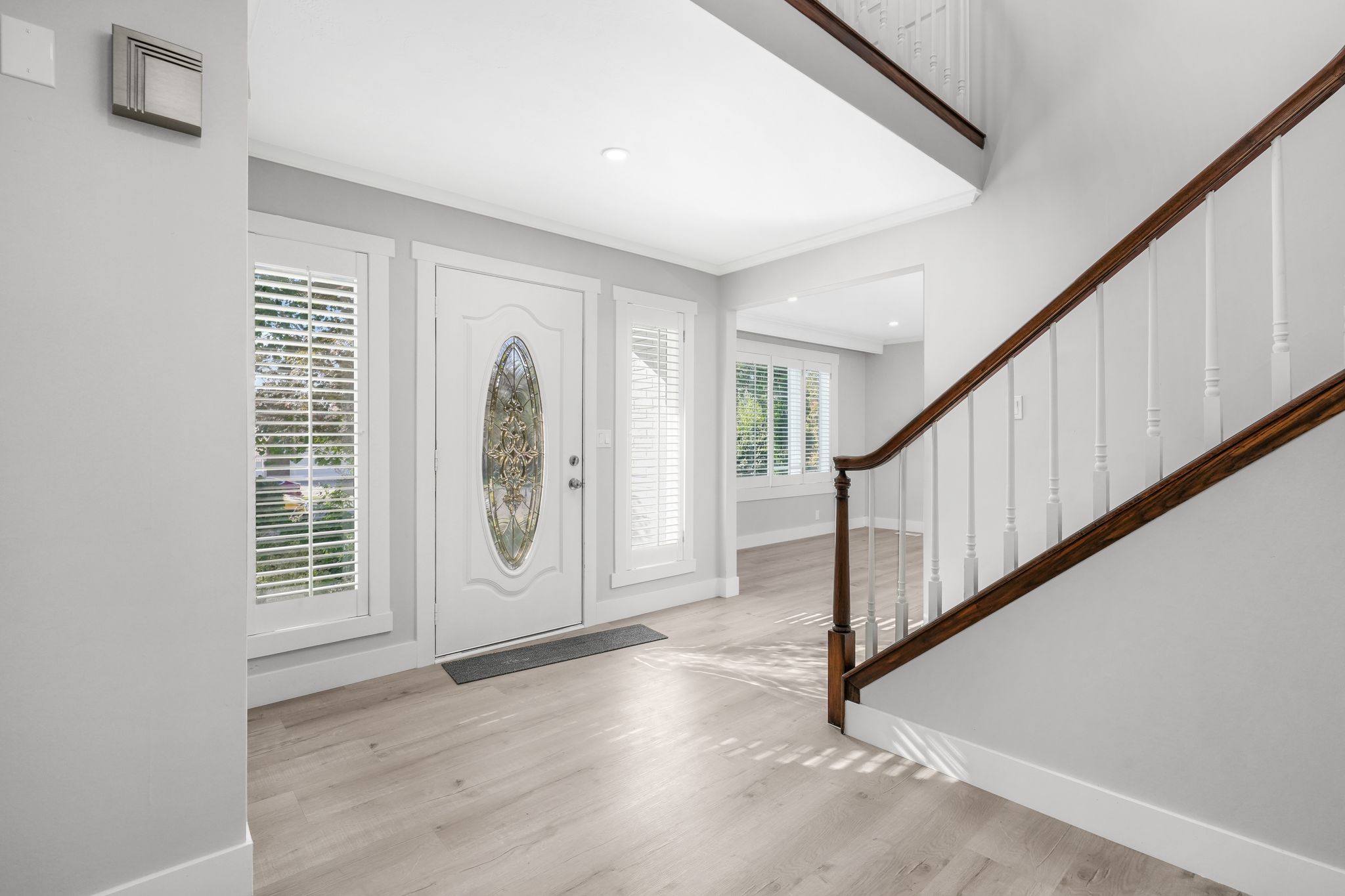 Foyer featuring light wood-style flooring, ornamental molding, and recessed lighting