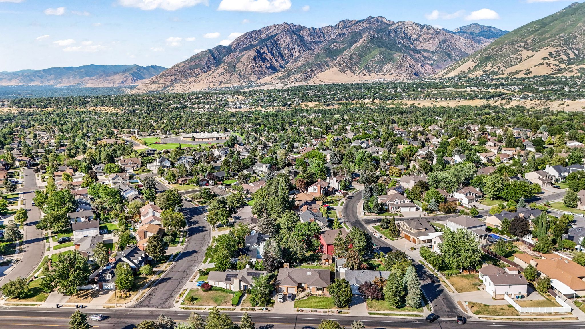 Aerial perspective of suburban area featuring a mountain backdrop
