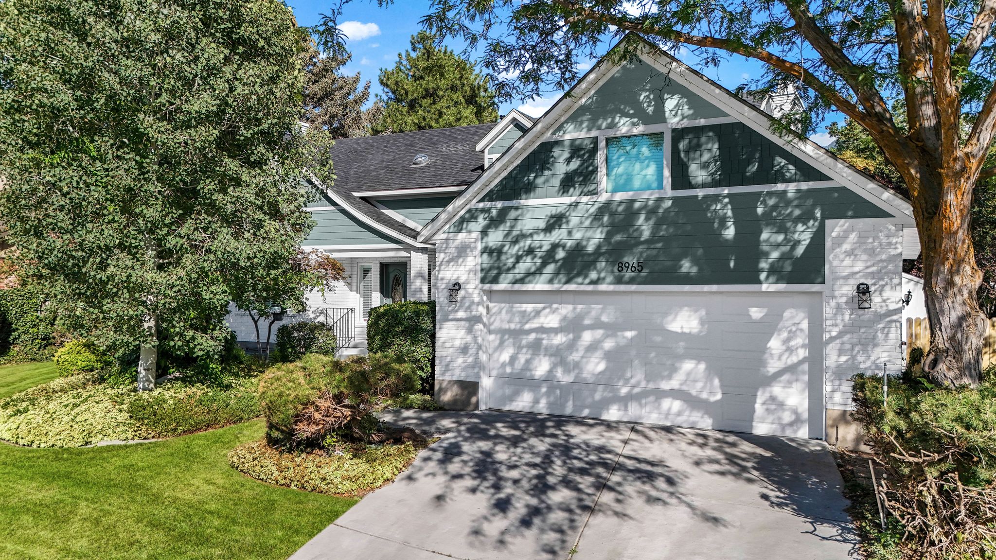 View of front of house with driveway and a front lawn
