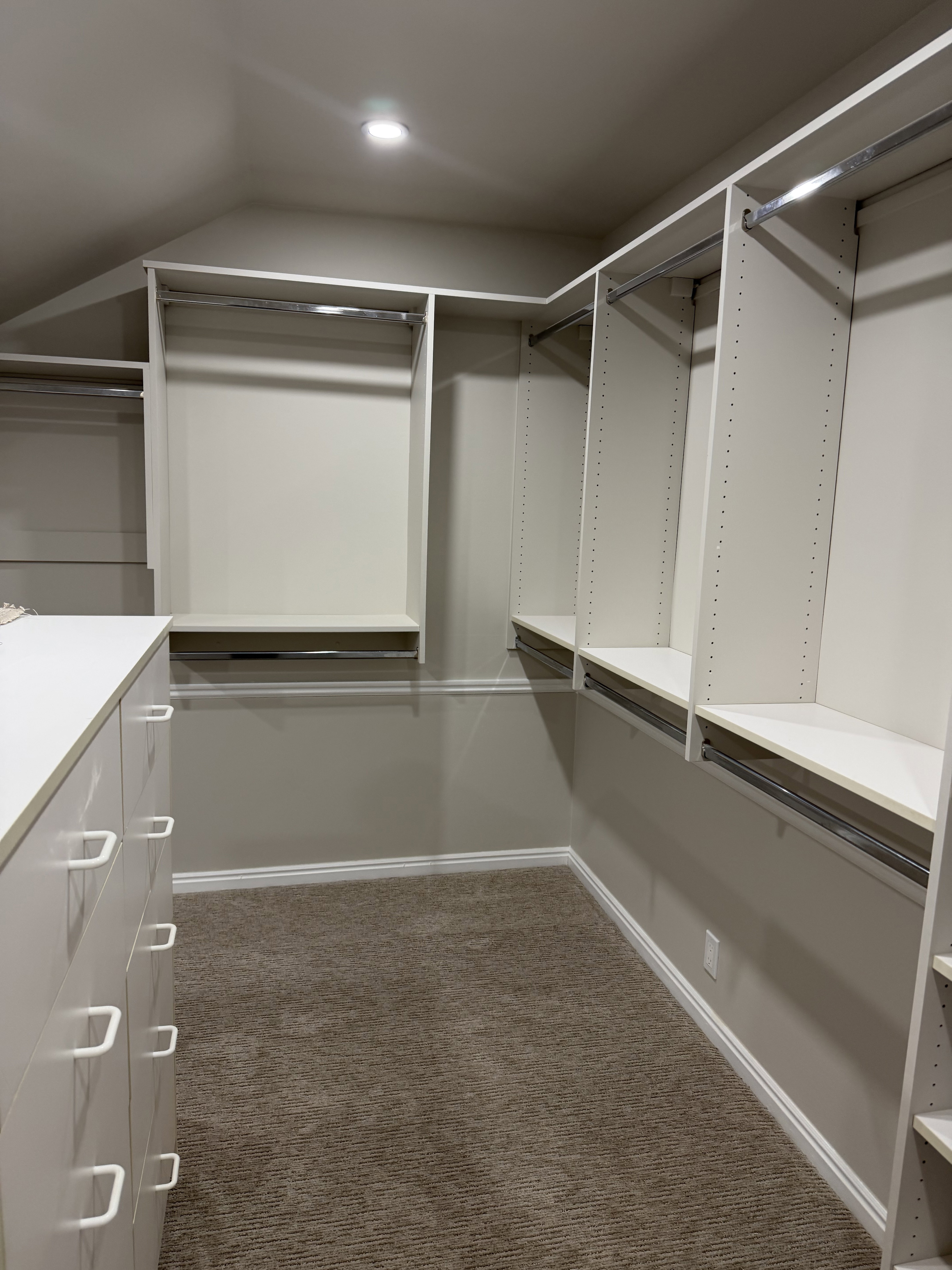 Walk in closet featuring dark colored carpet and lofted ceiling