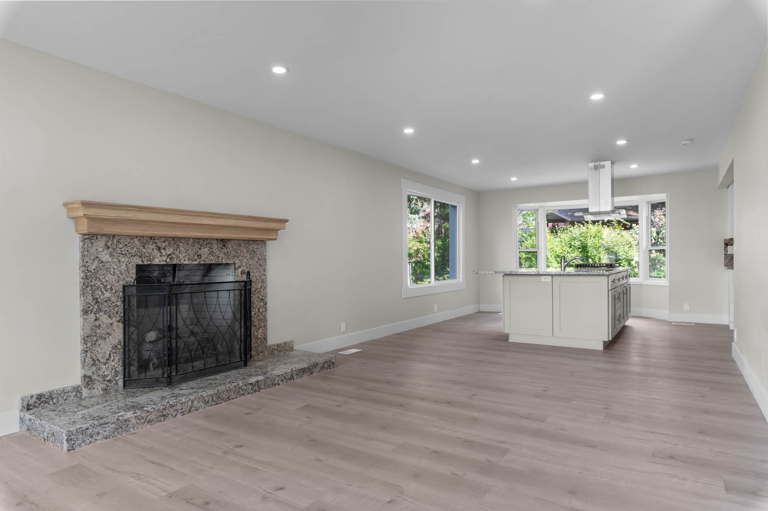 Unfurnished living room featuring recessed lighting, light wood finished floors, and a fireplace