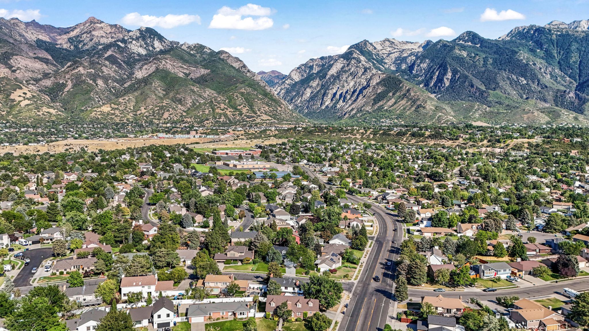 Aerial perspective of suburban area featuring a mountainous background