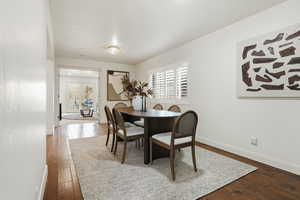 Dining space featuring french doors and dark wood-style flooring