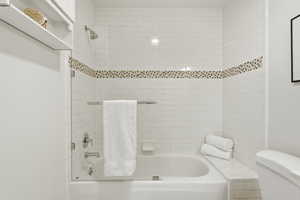 Bathroom featuring toilet and shower / tub combination