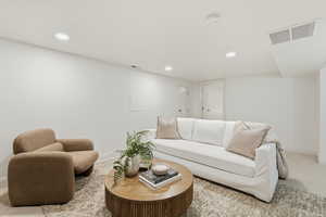 Living area featuring light carpet and recessed lighting