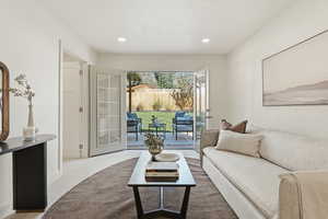 Carpeted living area with recessed lighting