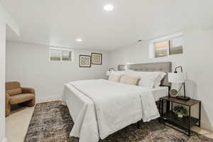 Carpeted bedroom with recessed lighting and baseboards
