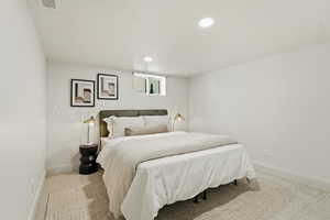 Bedroom with recessed lighting and light carpet