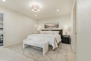 Bedroom featuring light carpet and recessed lighting