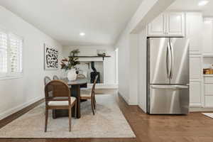 Dining room with recessed lighting and dark wood-style flooring