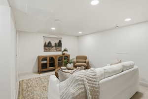 Living area featuring recessed lighting and light carpet