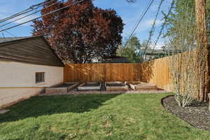 Fenced backyard with a garden