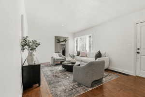 Living room featuring baseboards and hardwood / wood-style floors