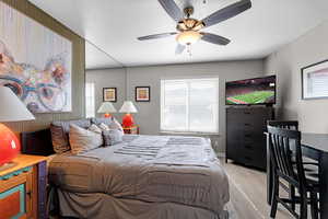 Bedroom with light wood-type flooring and a ceiling fan