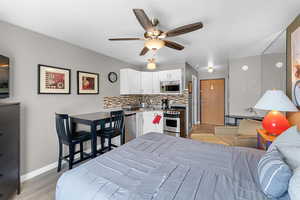 Bedroom with light wood-style flooring and a ceiling fan
