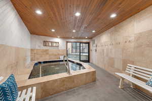 View of swimming pool featuring an in-ground hot tub