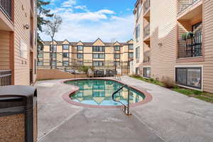 Community pool with a patio