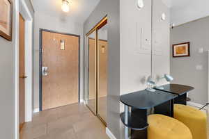 Hall featuring light tile patterned floors