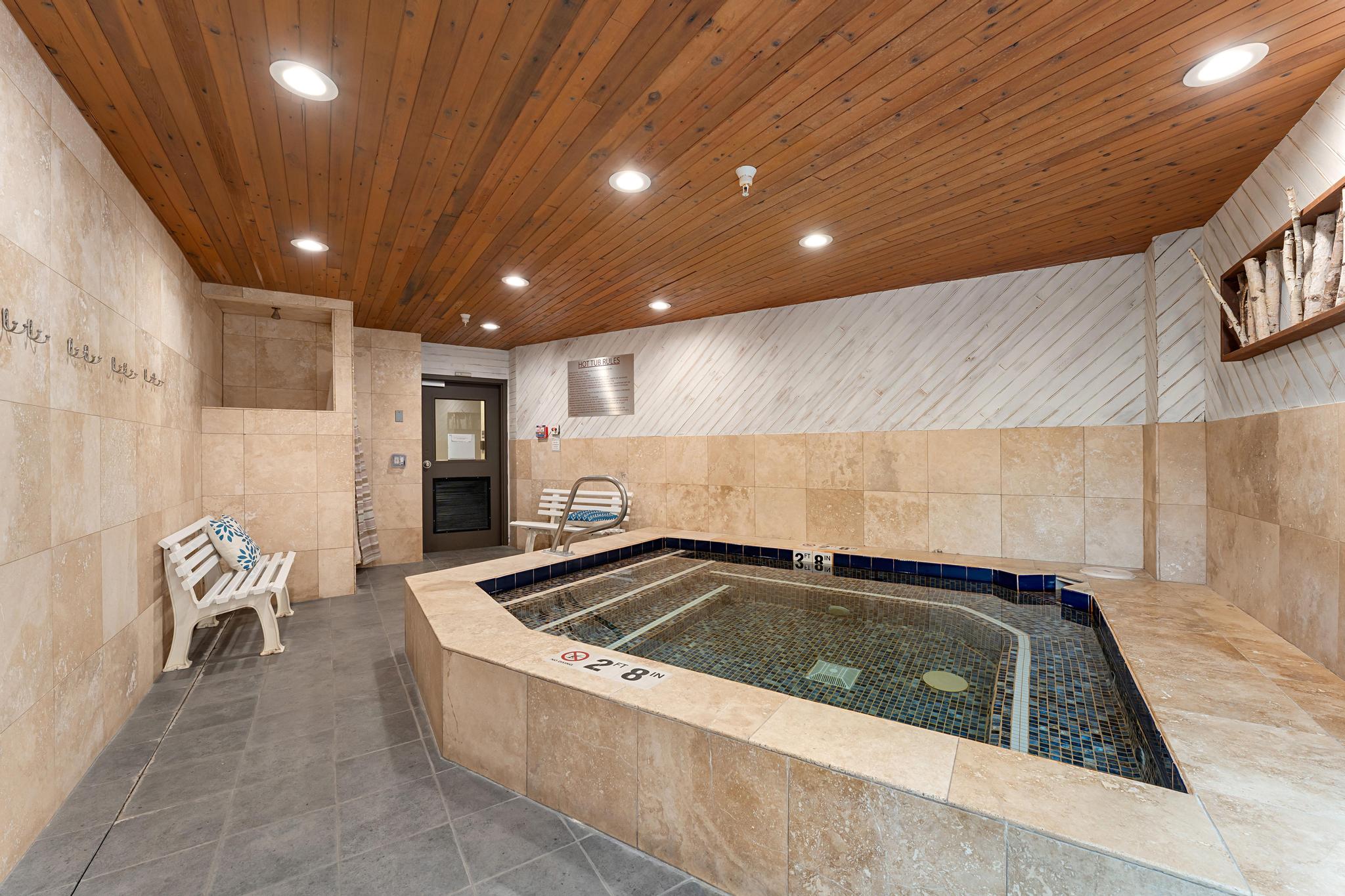 Kitchen featuring tile walls, recessed lighting, dark tile patterned flooring, light wood finish cabinets, and wooden ceiling