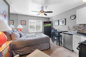 Bedroom with a ceiling fan and light wood-style flooring