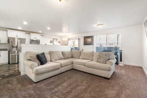 Living area with a chandelier and dark carpet
