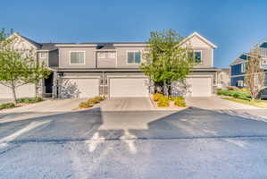 View of front of property featuring a garage and driveway