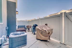 Fenced backyard with a grill and a patio