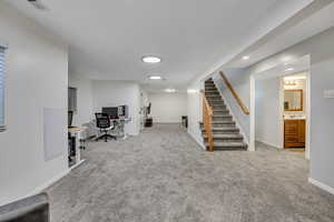 Office space with light carpet and baseboards