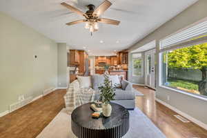 Living area featuring recessed lighting, a ceiling fan, and light wood finished floors
