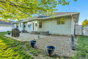 Back of property with stucco siding, a patio area, a gate, and entry steps