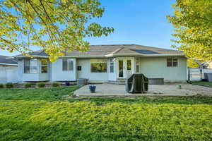 Rear view of property with a patio, stucco siding, french doors, a shingled roof, and a gate