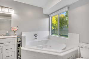 Bathroom featuring a jetted tub and vanity