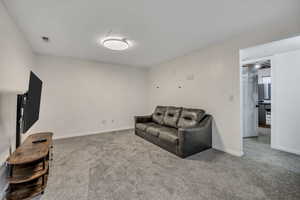 Sitting room with carpet flooring and electric panel