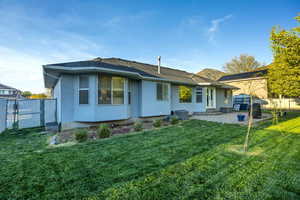 Back of property with a patio, stucco siding, and a gate