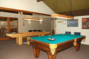 Rec room featuring a high wood beamed ceiling, french doors, and billiards