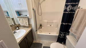 Primary Bathroom with vanity, shower / tub combo with curtain.