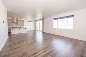 Unfurnished living room featuring dark wood finished floors and recessed lighting