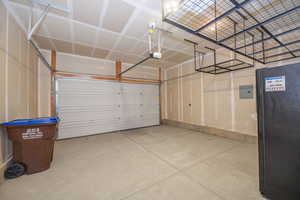 Garage with freestanding refrigerator and electric panel