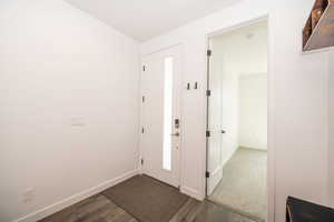 Entryway featuring dark wood-style floors