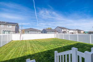 Fenced backyard with a residential view
